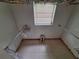 Bright walk-in closet featuring ample hanging space and a natural light source at 7100 Ashwood Dr, Port Richey, FL 34668