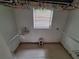 Spacious walk-in closet with rods for hanging clothes and a small window at 7100 Ashwood Dr, Port Richey, FL 34668