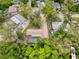 An aerial view of a residence with a screened pool and mature landscaping at 7119 Lenape Cir, New Port Richey, FL 34653