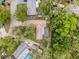 An aerial view of a single-Gathering home with a pool and lush greenery at 7119 Lenape Cir, New Port Richey, FL 34653