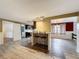 Open bar area with stools, wood floors, and modern lighting at 7119 Lenape Cir, New Port Richey, FL 34653