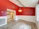 Bright dining area with wainscoting, bold accent wall, and modern chandelier at 7119 Lenape Cir, New Port Richey, FL 34653