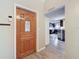 Inviting entryway with wood-look flooring and views into the kitchen at 7119 Lenape Cir, New Port Richey, FL 34653