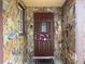 Close-up of a charming front door with stone accents and a decorative wreath at 7119 Lenape Cir, New Port Richey, FL 34653