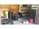 Garage interior with some shelving units and personal items inside at 7119 Lenape Cir, New Port Richey, FL 34653
