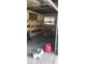 Garage interior with some shelving units and personal items inside at 7119 Lenape Cir, New Port Richey, FL 34653