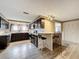 Modern kitchen with dark cabinets, granite countertops, and stainless steel appliances at 7119 Lenape Cir, New Port Richey, FL 34653