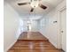 Inviting living room with hardwood floors, ceiling fan, and access to other rooms at 7119 Lenape Cir, New Port Richey, FL 34653