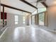 Bright and airy living room with high ceilings, tile floors, and large windows at 7119 Lenape Cir, New Port Richey, FL 34653