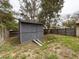Backyard shed for storing tools, gardening supplies, or extra storage space at 7119 Lenape Cir, New Port Richey, FL 34653