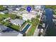 Tranquil waterfront home with canal access, a private pool, and lush green landscaping at 7313 Hatteras Dr, Hudson, FL 34667