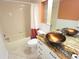 Bathroom featuring vessel sinks, a unique granite countertop, and decorative window block above the bathtub at 7313 Hatteras Dr, Hudson, FL 34667