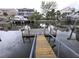 Picturesque waterfront view with a charming private dock, complete with seating to enjoy serene water views at 7313 Hatteras Dr, Hudson, FL 34667