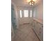Inviting entryway with tile floors, decorative door, and stylish storage cabinet at 7313 Hatteras Dr, Hudson, FL 34667