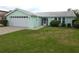 Charming single-story home with well-maintained lawn and attached garage at 7313 Hatteras Dr, Hudson, FL 34667