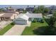 Inviting single-story home with a well-manicured lawn and mature landscaping at 7313 Hatteras Dr, Hudson, FL 34667