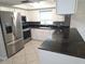 Modern kitchen featuring stainless steel appliances and sleek dark countertops at 7313 Hatteras Dr, Hudson, FL 34667