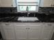 Close-up of the kitchen sink area showing granite countertops at 7313 Hatteras Dr, Hudson, FL 34667