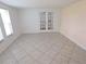 Bright living room with tile flooring and elegant French doors at 7313 Hatteras Dr, Hudson, FL 34667