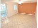 Bright living room featuring neutral tile flooring, a modern ceiling fan, and a distinctive accent wall at 7313 Hatteras Dr, Hudson, FL 34667