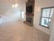 Living room featuring a stone fireplace, flat-screen TV, and tile floors at 7313 Hatteras Dr, Hudson, FL 34667