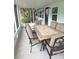 Screened in patio with a tile table and seating at 7313 Hatteras Dr, Hudson, FL 34667