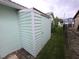 Exterior shot of a green vinyl shed, providing extra storage space for lawn and garden tools and equipment at 7313 Hatteras Dr, Hudson, FL 34667