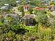 Aerial view of a home showcasing its backyard, patio, and surrounding lush greenery at 7340 Brightwaters Ct, New Port Richey, FL 34652
