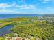 Expansive aerial view showcasing a coastal community with stunning waterways, lush greenery, and a view of the ocean at 7340 Brightwaters Ct, New Port Richey, FL 34652