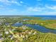 Stunning aerial view of a waterfront community with homes along winding waterways, under a clear blue sky at 7340 Brightwaters Ct, New Port Richey, FL 34652