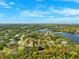 Beautiful aerial view of waterfront homes in a lush, green community under a bright blue sky at 7340 Brightwaters Ct, New Port Richey, FL 34652