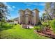 Multi-story home with a well-maintained backyard featuring a patio and fire pit area at 7340 Brightwaters Ct, New Port Richey, FL 34652