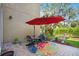 Cozy back patio featuring a vibrant outdoor rug, umbrella, and comfortable seating area at 7340 Brightwaters Ct, New Port Richey, FL 34652