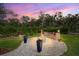 Outdoor fire pit area with ambient lighting, surrounded by lush greenery, perfect for gatherings at 7340 Brightwaters Ct, New Port Richey, FL 34652