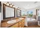 Bathroom with a dual sink vanity and tiled tub, offering lots of space and lighting at 7340 Brightwaters Ct, New Port Richey, FL 34652