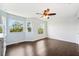 Bright bedroom with plenty of natural light, featuring hardwood floors and ceiling fan at 7340 Brightwaters Ct, New Port Richey, FL 34652