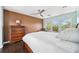 Well-lit bedroom boasts dark wood floors and an expansive view of tropical landscaping at 7340 Brightwaters Ct, New Port Richey, FL 34652