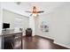 An airy room featuring hardwood floors, a ceiling fan, with an arched window that provides lots of natural light at 7340 Brightwaters Ct, New Port Richey, FL 34652