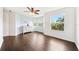 Bedroom features hard wood floors and a large window with great views, with modern ceiling fan at 7340 Brightwaters Ct, New Port Richey, FL 34652