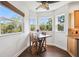 Bright breakfast nook with views of surrounding greenery and a ceiling fan at 7340 Brightwaters Ct, New Port Richey, FL 34652
