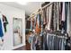 Walk-in closet with ample hanging space and shelving for optimal organization and clothing storage at 7340 Brightwaters Ct, New Port Richey, FL 34652