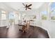 Bright breakfast nook with backyard view from the windows, table, and a ceiling fan at 7340 Brightwaters Ct, New Port Richey, FL 34652