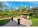 Outdoor fire pit with brick surround and built-in seating, perfect for enjoying cool evenings at 7340 Brightwaters Ct, New Port Richey, FL 34652