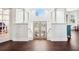 Bright foyer featuring hardwood floors, white columns, and a window above the doors at 7340 Brightwaters Ct, New Port Richey, FL 34652