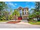 Beautiful two-story home featuring a manicured lawn and a palm tree in the front yard at 7340 Brightwaters Ct, New Port Richey, FL 34652