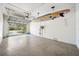 Spacious garage featuring a paddleboard hanging from the ceiling, offering ample room for storage and vehicles at 7340 Brightwaters Ct, New Port Richey, FL 34652