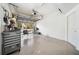 Organized garage space showcasing an open door leading to an outdoor seating area, plus a large tool chest at 7340 Brightwaters Ct, New Port Richey, FL 34652