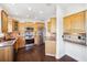 Kitchen with light wood cabinets, stainless steel appliances, and dark hardwood floors at 7340 Brightwaters Ct, New Port Richey, FL 34652