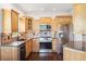 Bright kitchen with stainless steel appliances, wooden cabinetry, and tile backsplash at 7340 Brightwaters Ct, New Port Richey, FL 34652