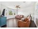 Bright living room features hardwood floors, lots of natural light, and a modern ceiling fan at 7340 Brightwaters Ct, New Port Richey, FL 34652
